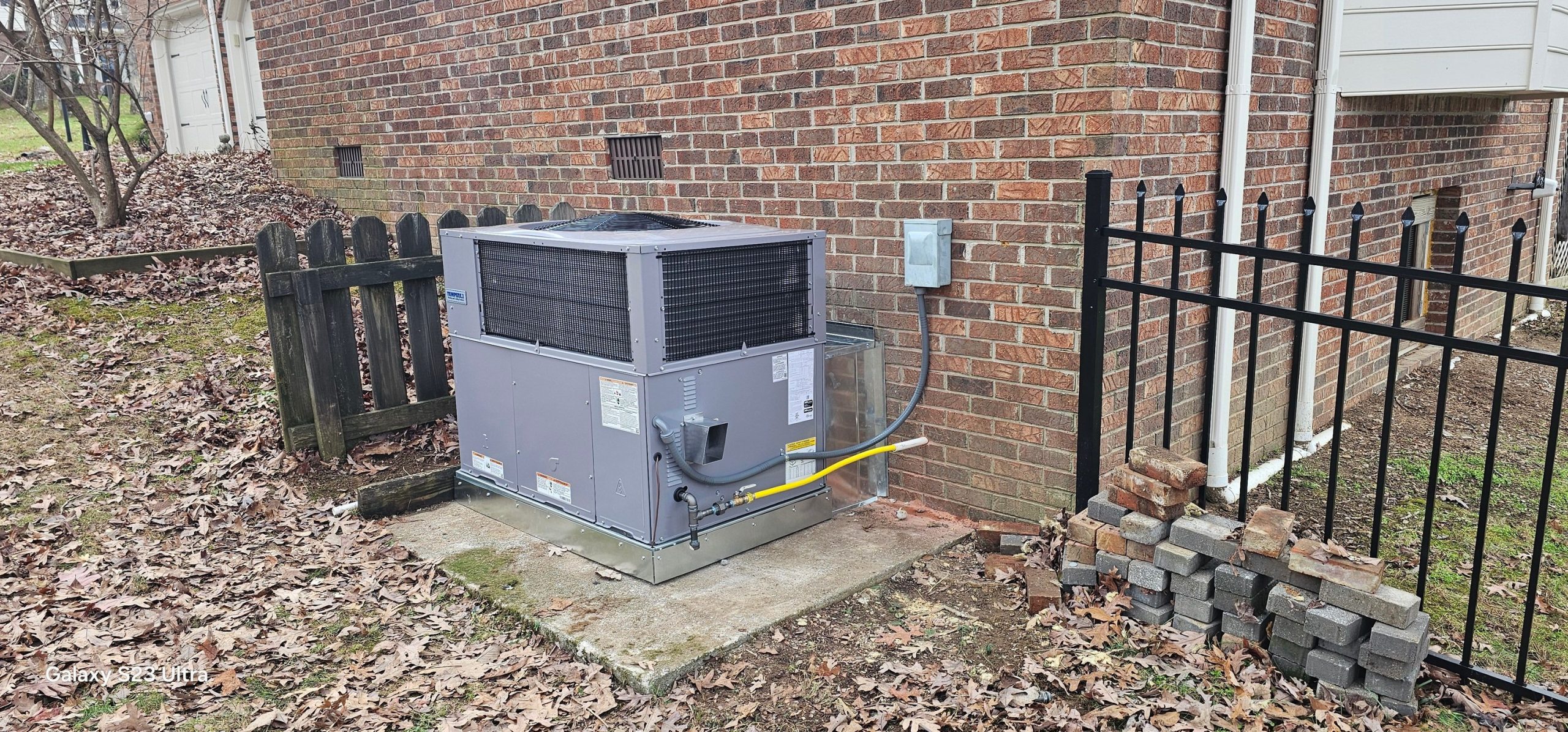 An outdoor condenser is installed on a concrete pad beside a brick home in Jasper, TN — Kilgore Heating and Air