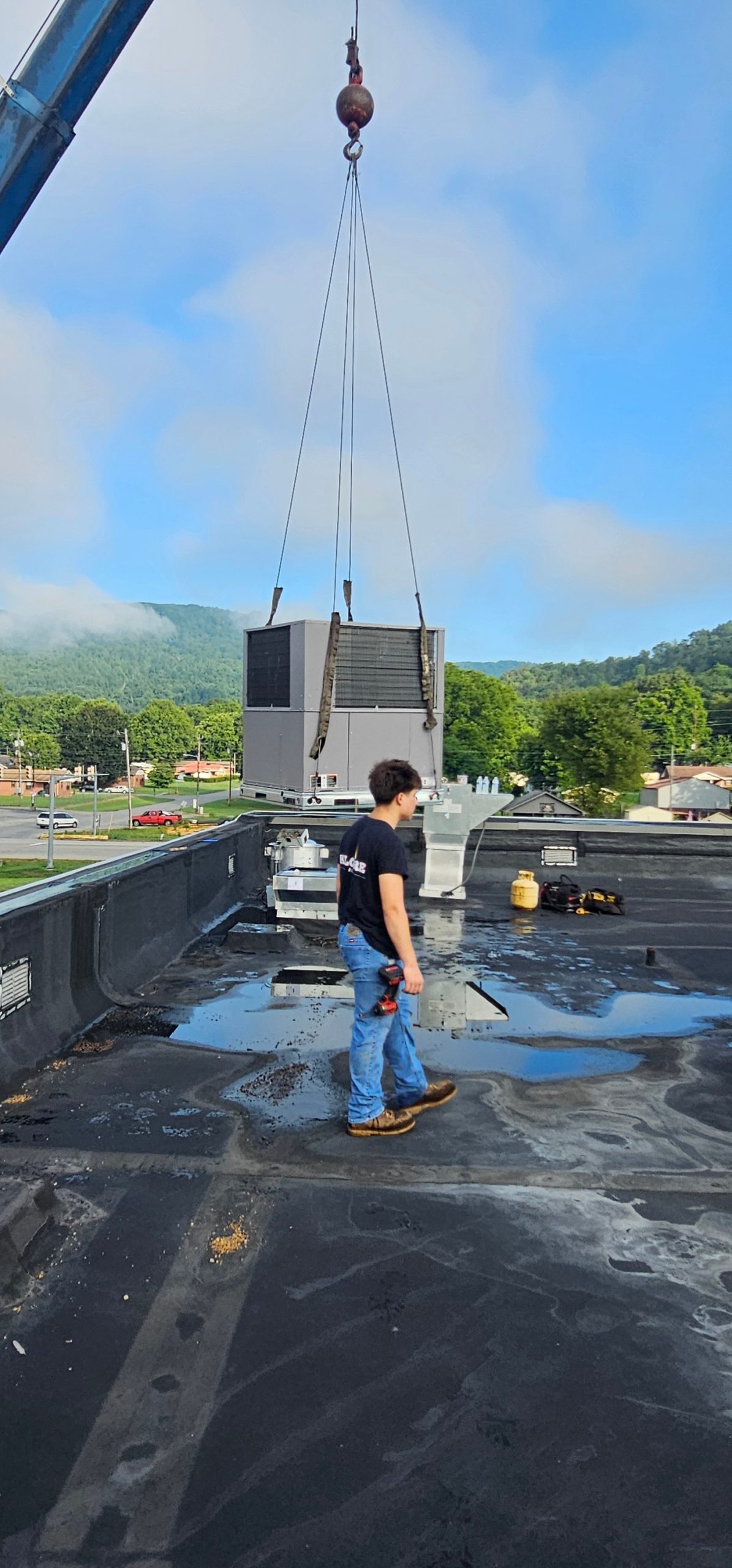 Package unit suspended above a Chattanooga-area commercial rooftop installation project