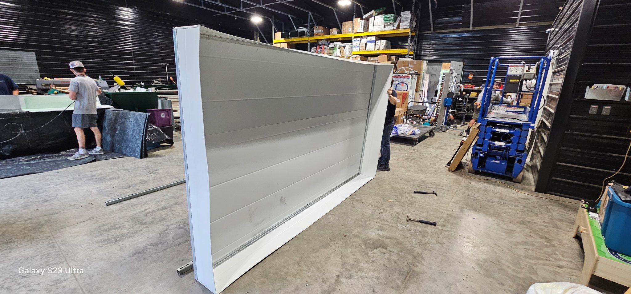 Kilgore worker fabricating a large custom sheet-metal panel in the shop — Kilgore Heating and Air