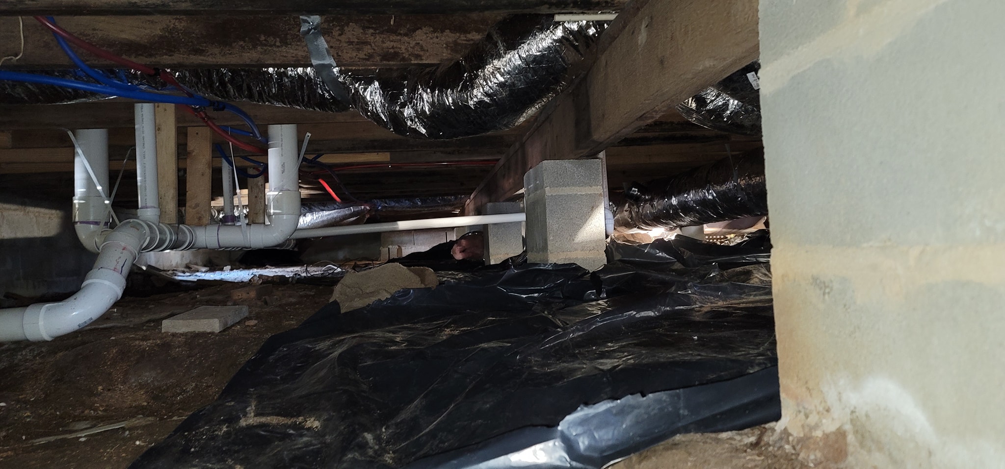 Crawlspace ductwork and drainage lines beneath a Whitwell TN home