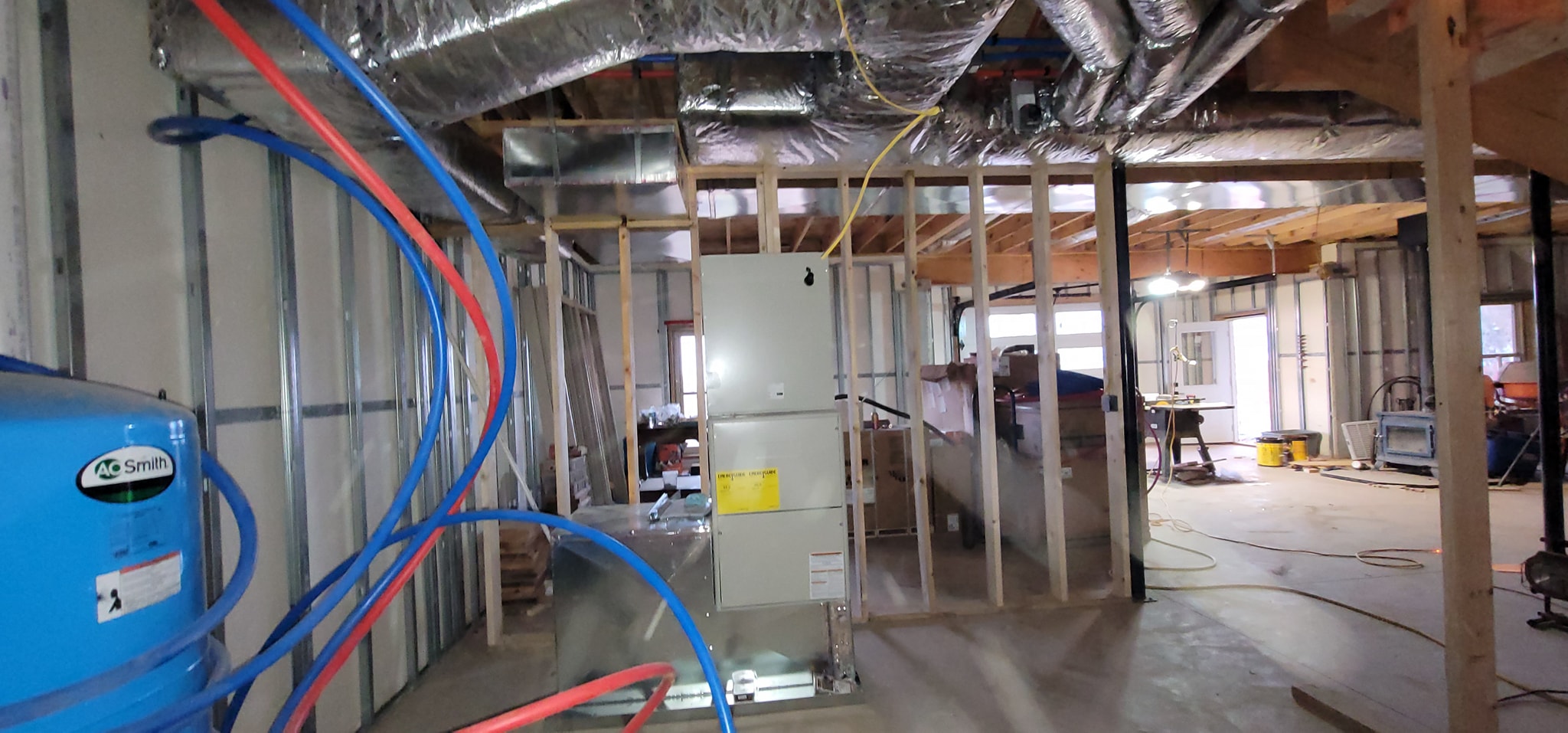 An air handler stands in an unfinished basement beside reflective insulated ductwork — diagnosing a furnace pilot light that will not stay lit