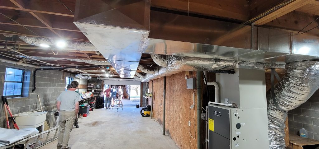 Basement furnace connected to custom metal ductwork project photo