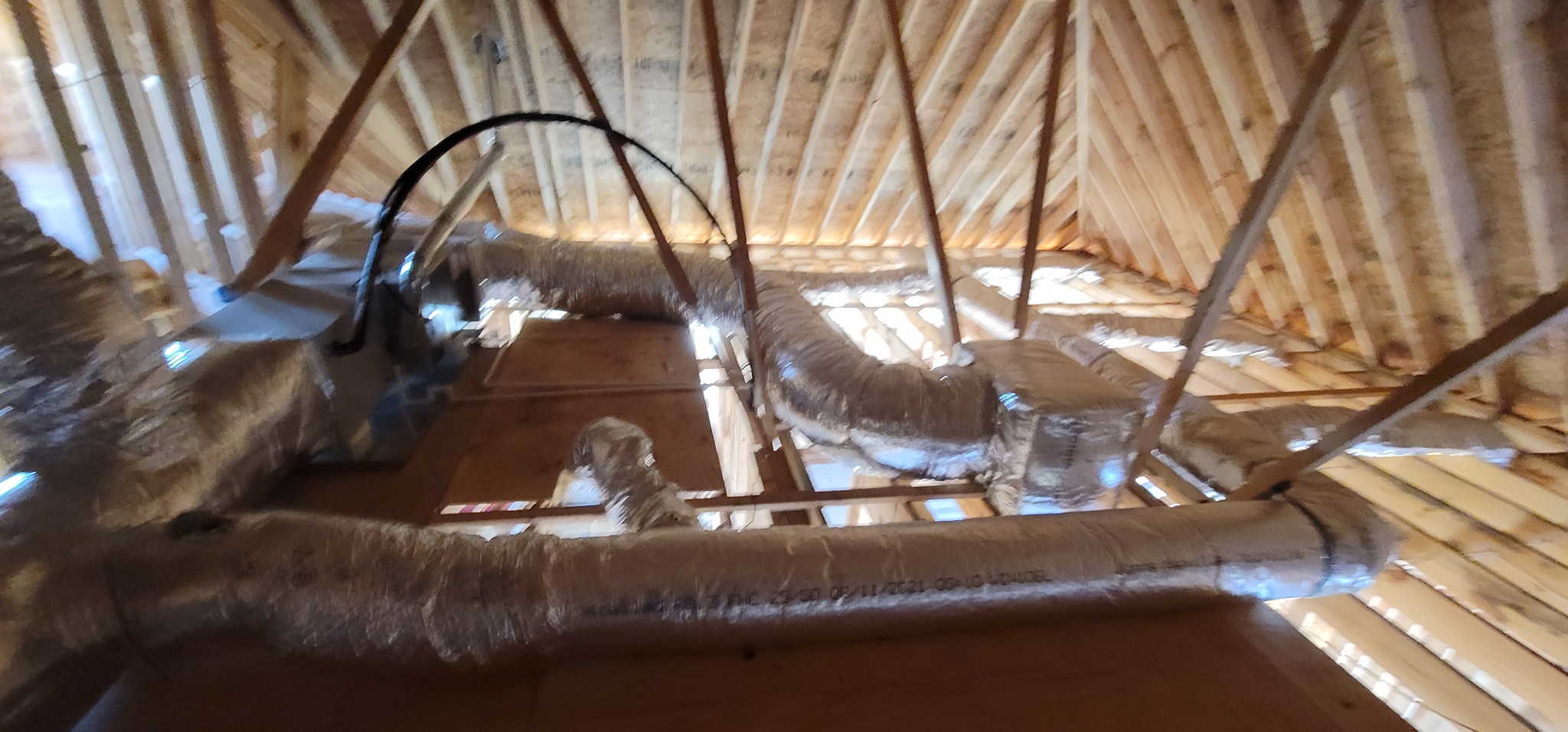 Reflective insulated flex ducts connect around a central attic distribution point — diagnosing one room that will not cool