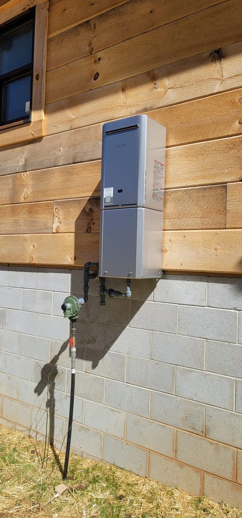 Rinnai tankless water heater and gas line mounted outdoors