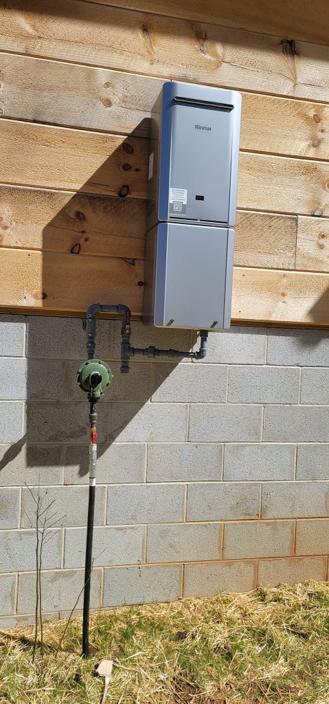 Rinnai tankless water heater and gas line mounted outdoors