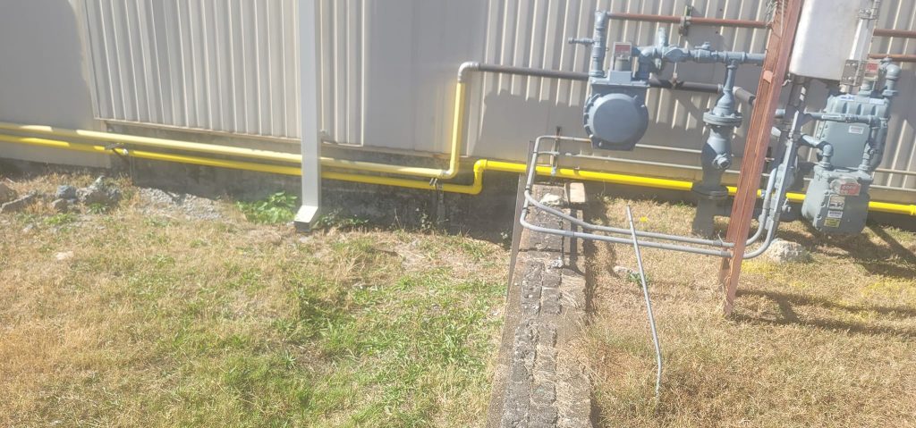 Commercial gas piping and regulators at building exterior