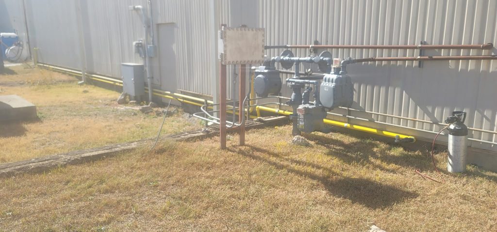 Commercial gas piping beside a metal building by Kilgore HVAC
