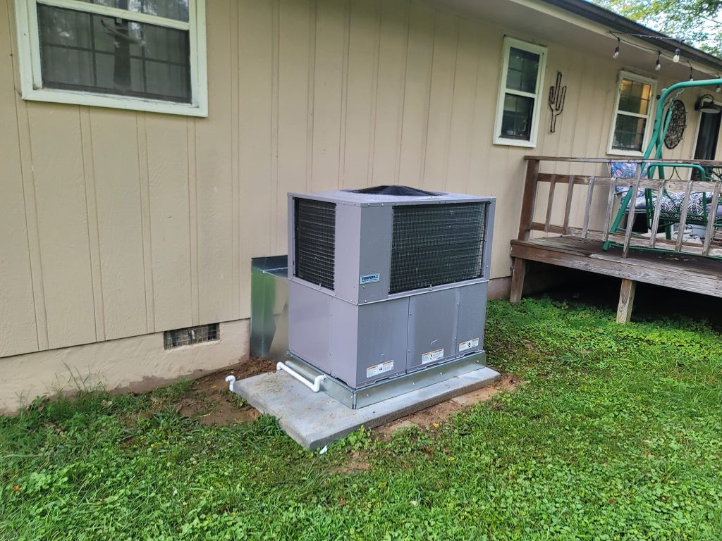 Gray package unit on a concrete pad