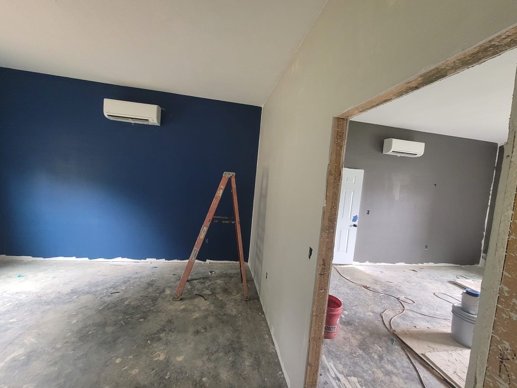 Wall-mounted mini-split on a blue interior wall