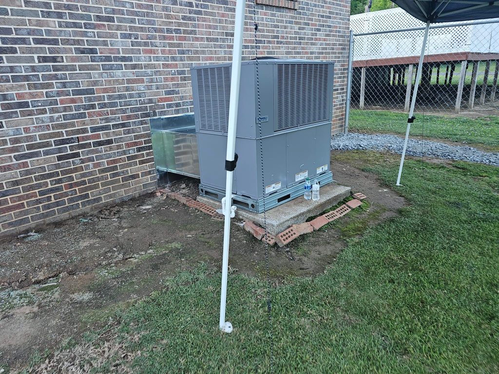 Gray package unit beside a brick building