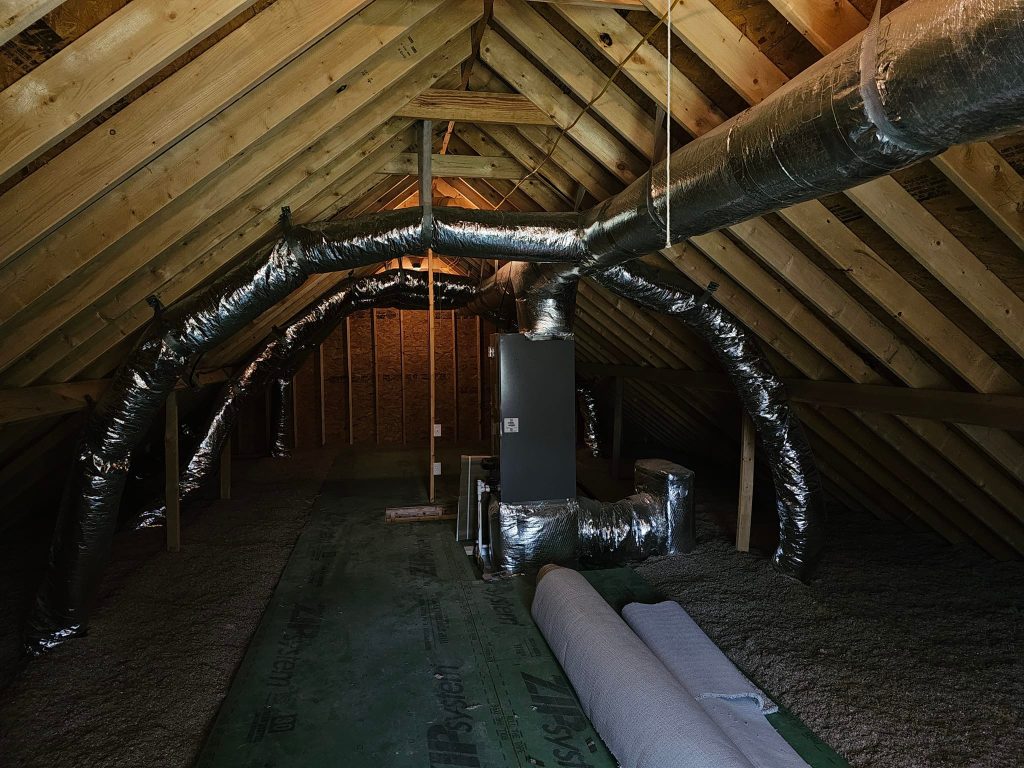 Insulated attic ductwork around an indoor unit in new construction