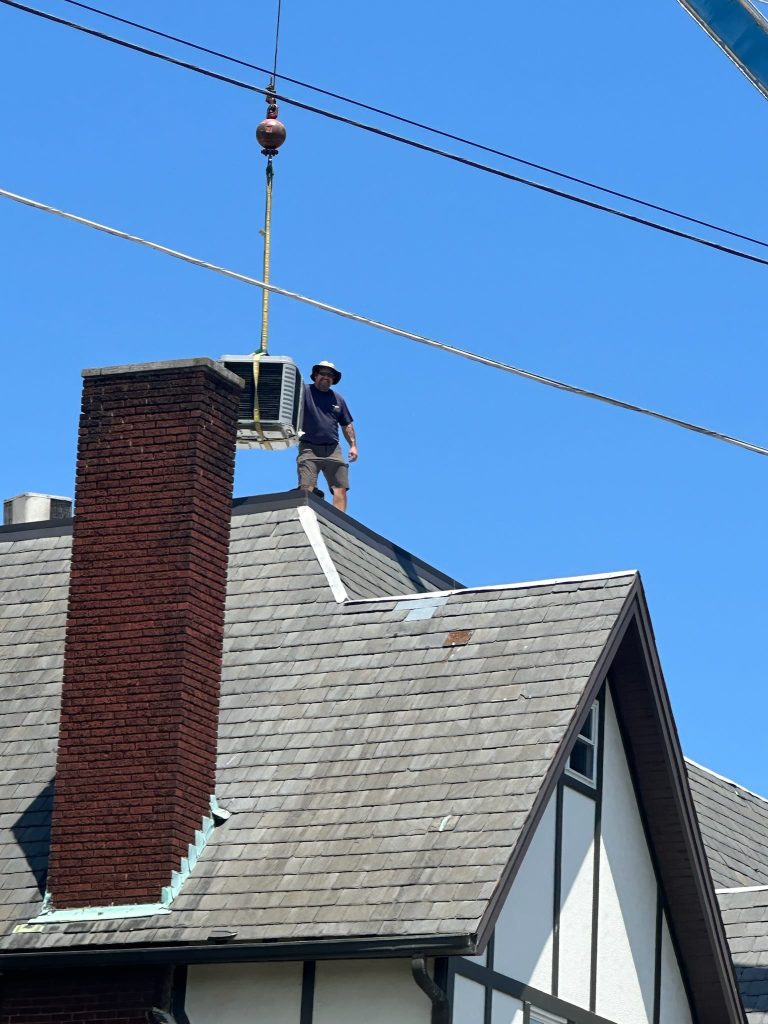 Crane-lifted rooftop HVAC equipment at a Chattanooga-area commercial building installation