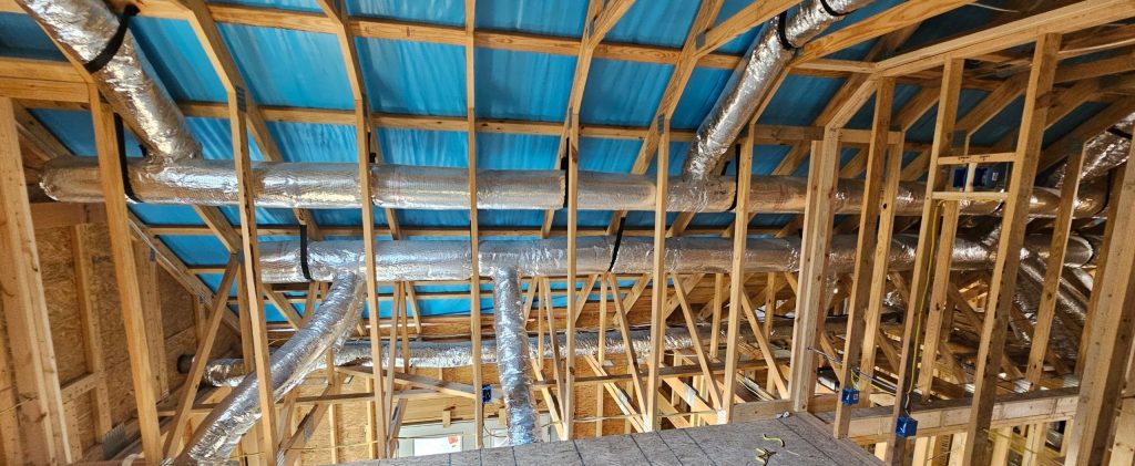 Insulated flex duct rough-in inside a Sequatchie Valley home build