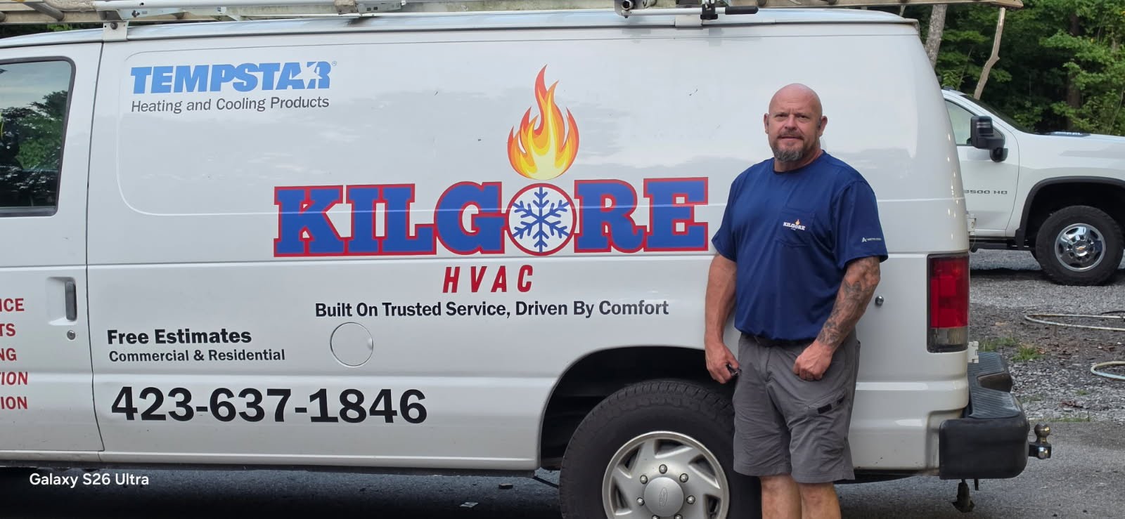 Sheddie Kilgore standing beside a Kilgore Heating and Air van in Whitwell Tennessee
